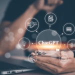 Person using a phone with holographic icons and a ChatGPT text projected above it.