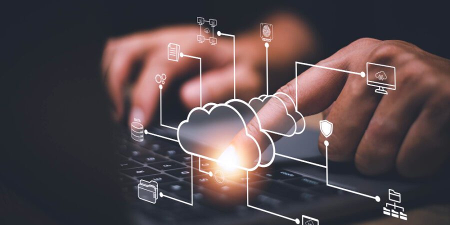 Cloud computing diagram overlaid on laptop typing to represent Boomi aXis connector for SAP